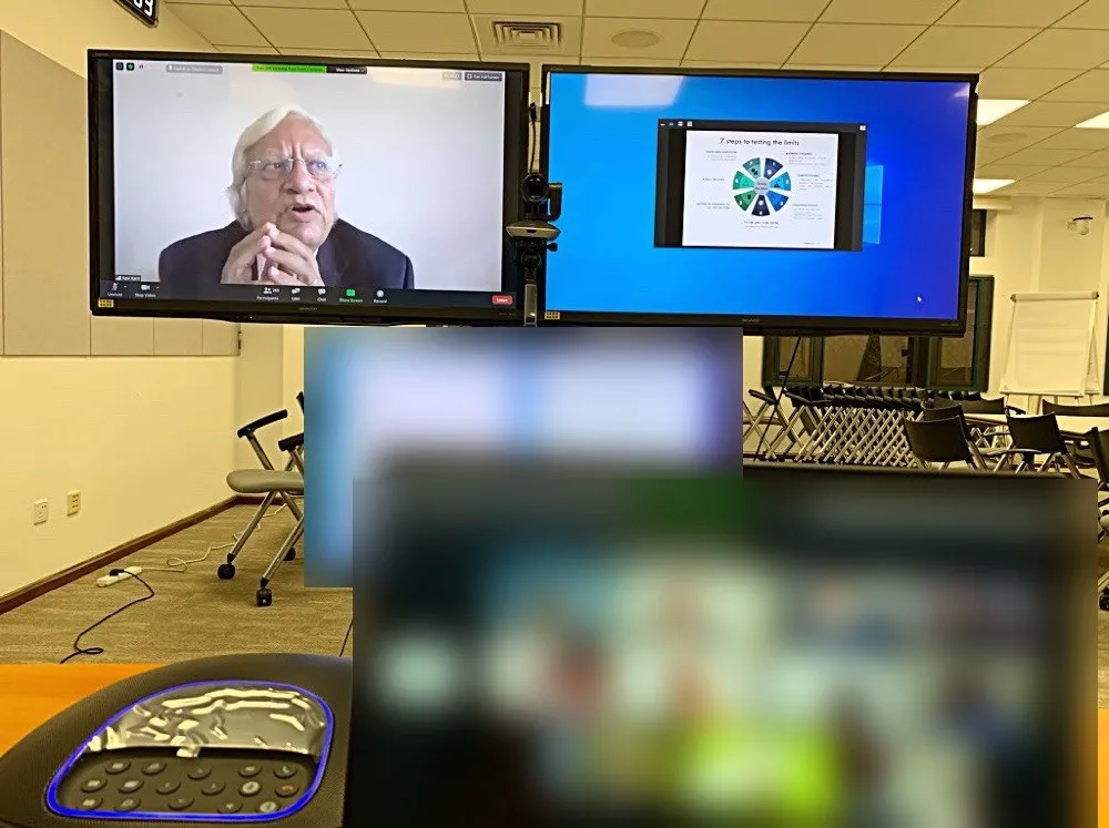 Mr Ravi Kant delivering his lecture on screen, with his slide “7 steps to testing the limits” on the screen beside him